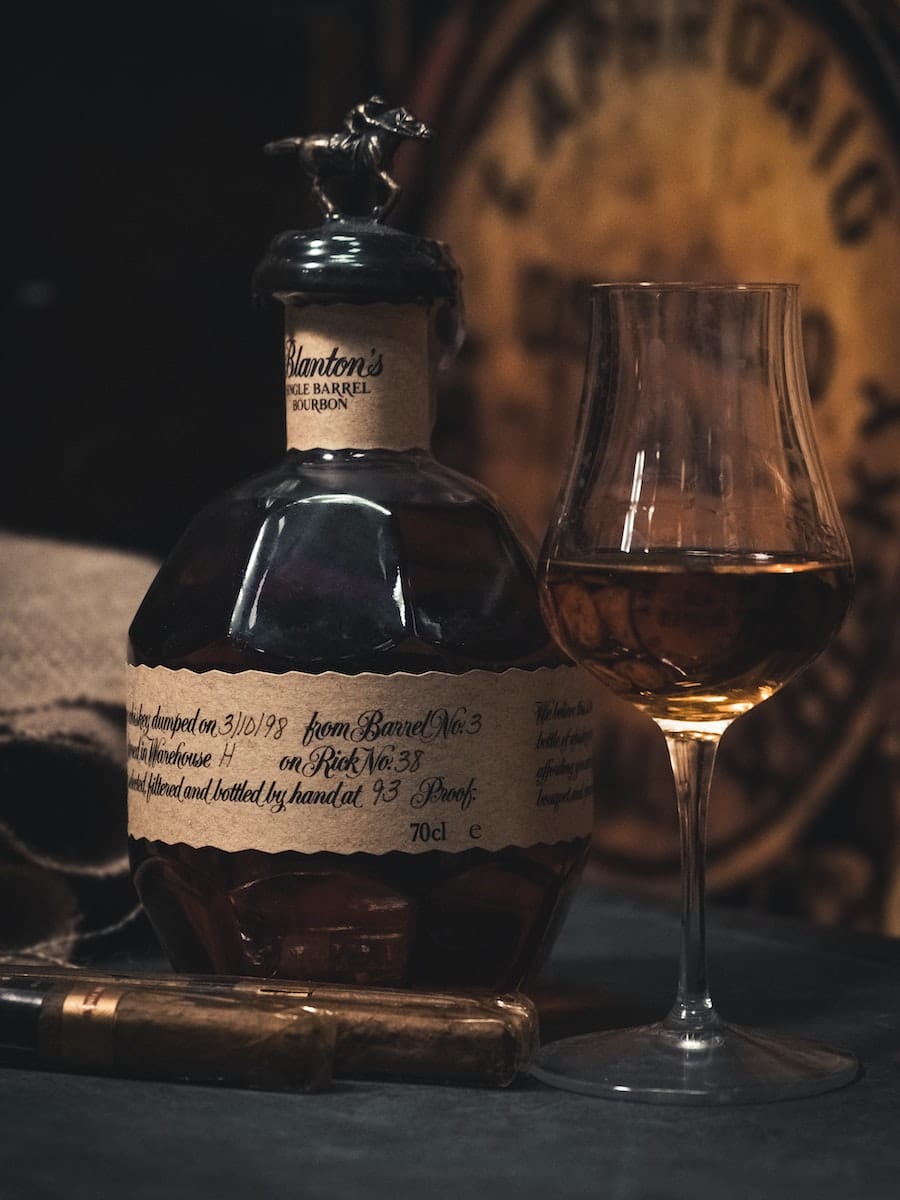White Labeled Bottle Beside Clear Wine Glass